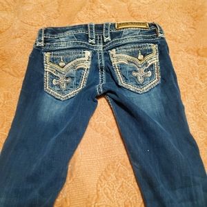 Like new Rock Revival jeans. Super cute design on back pockets. Long boot cut.